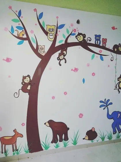 A hand-painted jungle mural brings a child's room to life. We designed this scene with friendly animals like monkeys, owls, and a deer to create a playful and imaginative space for kids.
