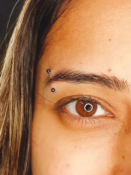 A sharp and clean eyebrow piercing. Placement is key for this type of facial piercing, and I work with you to find the exact spot that best suits your features.