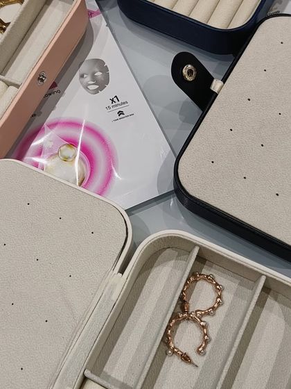 Another view of the travel jewelry boxes, shown here with sheet masks. It's a great combination for a self-care or travel-themed hamper.