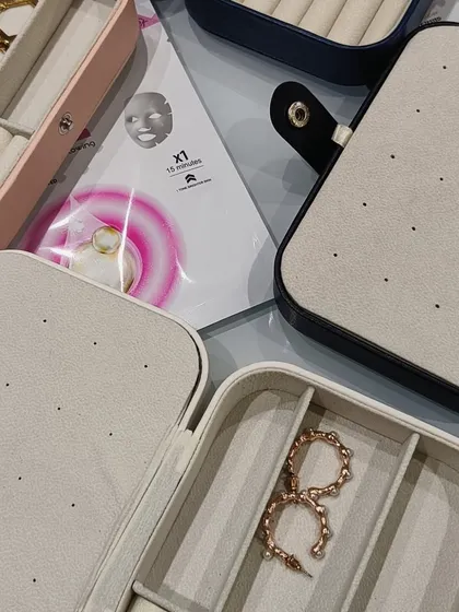 Another view of the travel jewelry boxes, shown here with sheet masks. It's a great combination for a self-care or travel-themed hamper.