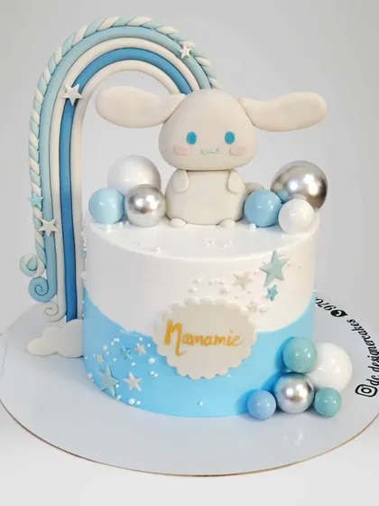 A sweet Cinnamoroll-themed cake with a blue rainbow and fluffy clouds. This design is perfect for a fan of the adorable Sanrio character.