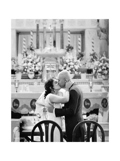 The first kiss as a married couple, a moment of pure joy and love captured at the altar of the church.