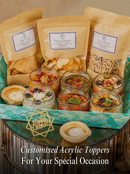 Make it truly yours. We offer custom acrylic toppers for any special occasion, like this 'Happy Diwali' one, to add a festive and personalized flair to your gourmet hamper.