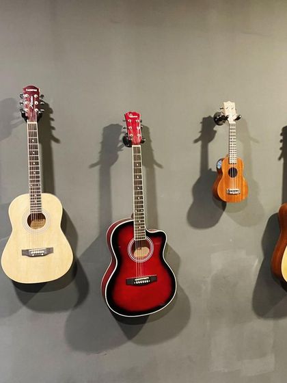 From the classic acoustic to the bright-sounding ukulele, we have a range of instruments ready for our students. This wall of guitars at our studio inspires students to pick one up and start their journey.