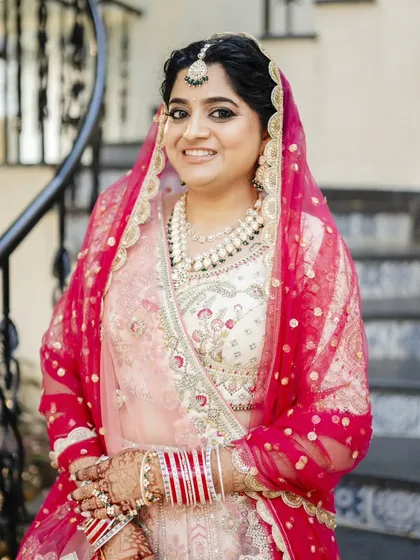 A series showcasing a beautiful sunset wedding look. The bride's makeup is soft and romantic, with a flawless base and defined eyes, perfectly complementing her stunning pastel lehenga for a picturesque Goa wedding.