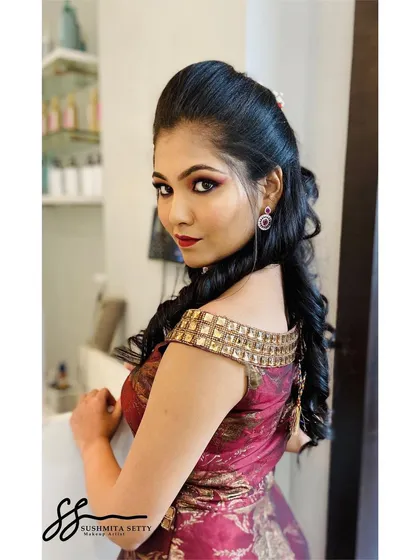 A beautiful shot showcasing the hairstyle and makeup for this Sangeet look. The voluminous curls and bold makeup create a stunning combination for an evening event.