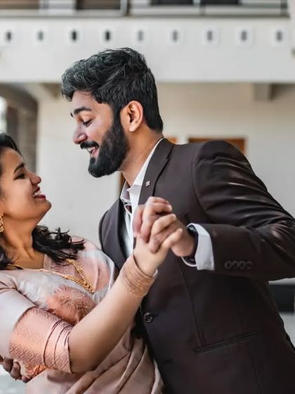 A candid moment of a couple dancing and laughing. We love capturing the fun and energy of your relationship in our pre-wedding photos.