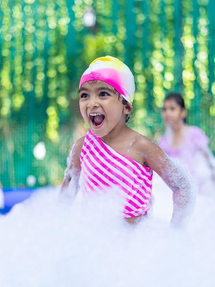 The excited face of a girl playing in the foam says it all. These are the moments of pure joy I aim to create at every party.