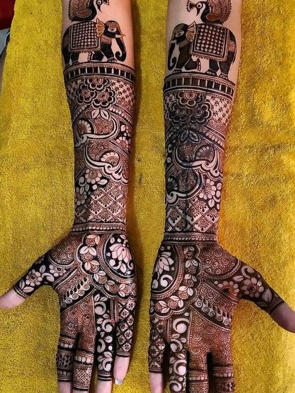 This full-arm design features majestic elephants and peacocks at the top, flowing into dense, intricate floral and geometric patterns for a truly grand statement.