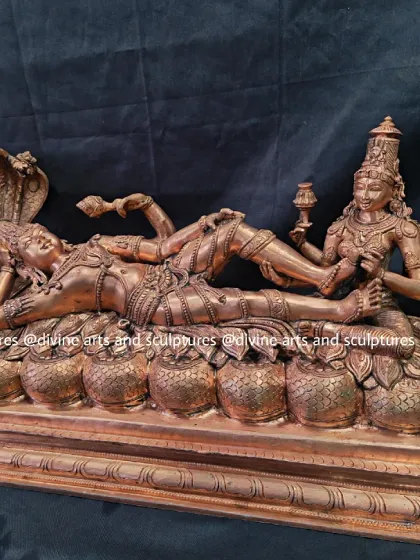 This sculpture depicts Lord Vishnu in Ananthasayanam, reclining on the serpent Adishesha, with Mahalakshmi at his feet. It is a serene representation of the cosmic preserver in yogic sleep.