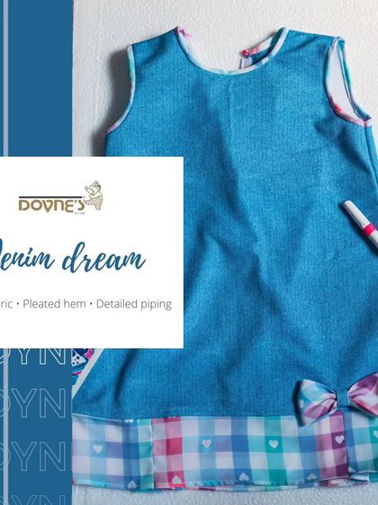 A graphic celebrating my "Denim Dream" dress, highlighting its unique combination of checks, pleats, and detailed piping.