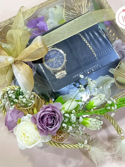 A closer look at the luxury watch included in our purple and white themed hamper, surrounded by delicate purple and white roses.