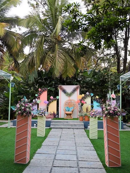 Another view of a colorful Seemantham ceremony at Farmhouse Collective, showing the full lawn setup with guest seating and stage decor.
