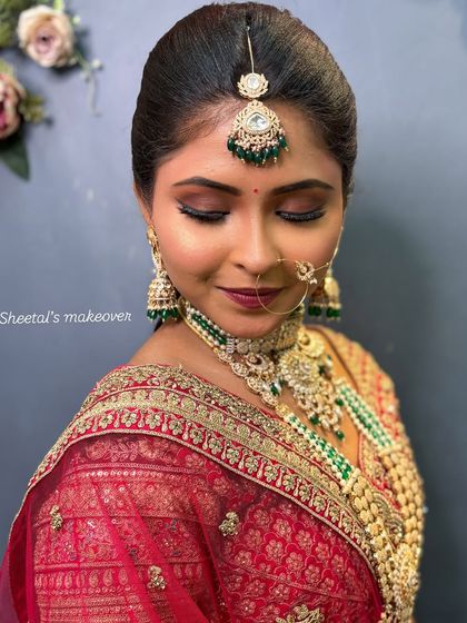 A stunning bridal portrait. The makeup features a classic smokey eye and a perfectly defined lip.