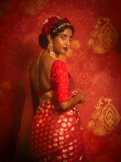 A beautiful back shot, highlighting the low-back blouse and the intricate floral hairstyle created for this look.