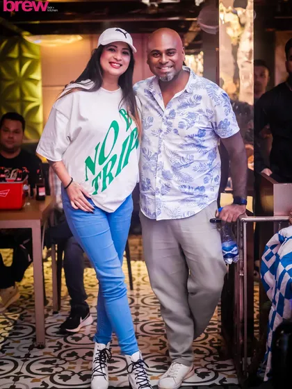 Posing with a guest at Happy Brew. I always make time to connect with the crowd, ensuring everyone feels welcome and part of the party.