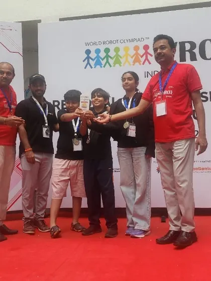Another team proudly displays their bronze medal from the WRO elementary category. We focus on building strong teamwork and problem-solving skills, which are essential for success in competitive robotics.
