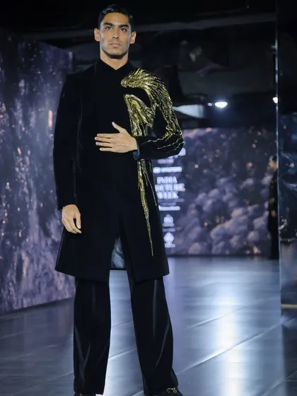 The wing-embroidered indowestern on the runway, showcasing its movement and powerful stage presence.
