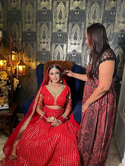 This is my element, where I share my passion and techniques with aspiring artists. This photo captures a moment from a hands-on session, showing the focused, personal guidance you'll receive in my classes.