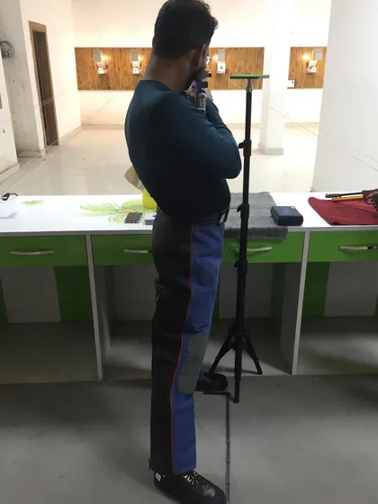 A rifle shooter demonstrating the correct posture and back alignment essential for stability in the sport.