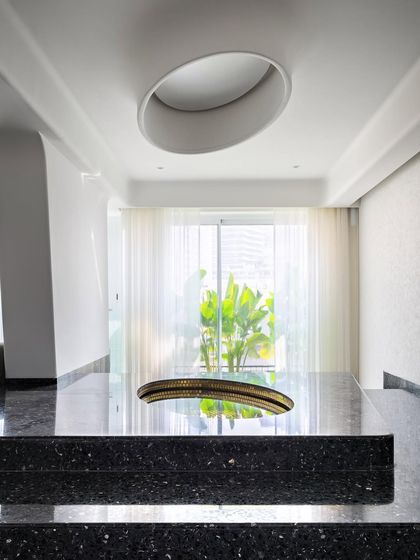 The reflective pool and sculptural ceiling form in Apartment 56. This space is designed as an experiential art piece, where light, form, and material come together to create a moment of calm and reflection.