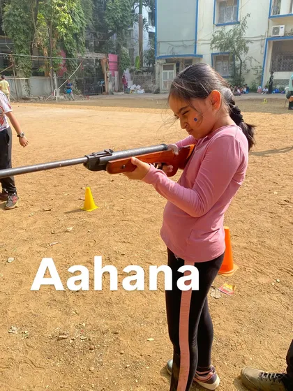 Aahana carefully aims her rifle, putting the lessons on stance and breathing into practice.