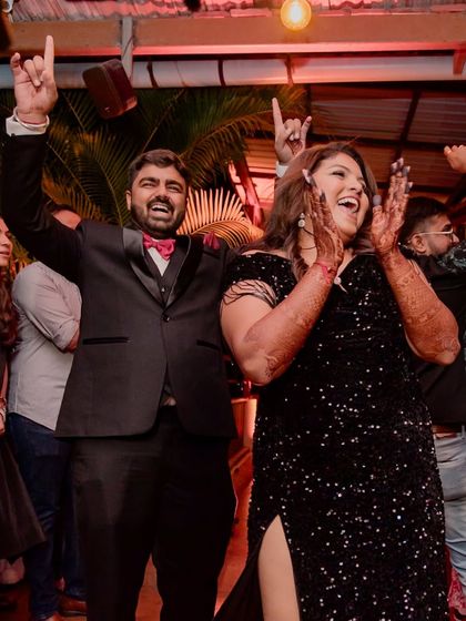 The couple enjoying their cocktail party in Alibaug. The candid shot captures the fun and relaxed atmosphere of a destination wedding event.