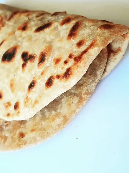 We never use factory-made bread. Every roll is wrapped in either a soft, homemade chapati or a special paratha, like this one made for our Bombay Kheema. It’s the foundation of a truly authentic roll.