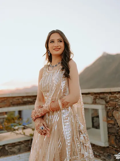 A beautiful portrait of the bride at her sangeet, enjoying the golden hour light at the Ramada resort in Udaipur.