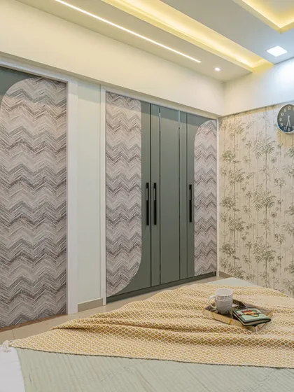 I designed the wardrobe and door to match, using a combination of sage green and a chevron-patterned laminate. This thematic approach ensures that every element in the room feels connected and thoughtfully planned.
