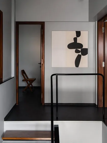 Another perspective of the upper landing, showing the interplay of art, doorways, and the staircase railing. I design these circulation spaces not just as paths, but as thoughtful moments within the home.