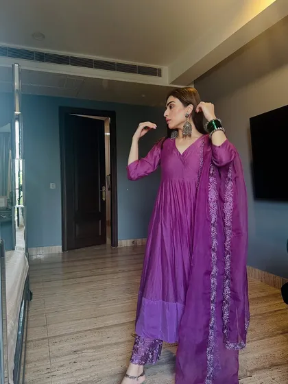 Another angle of the purple Anarkali, highlighting the heavy earrings and bangles that complete this festive look.