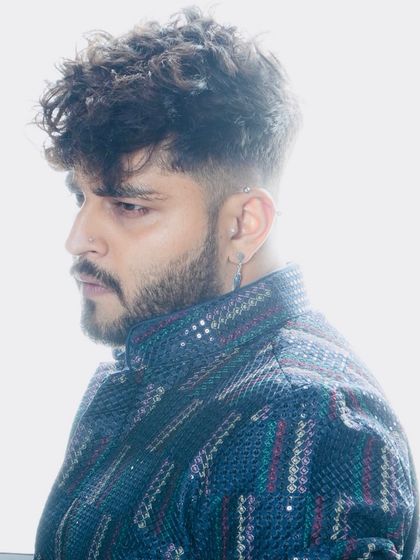 A close-up portrait showcasing the details of the jacket and the client's sharp haircut and grooming, which are key elements of the overall look.
