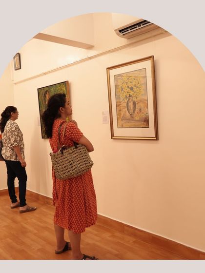 Two visitors admiring a still-life painting, a snapshot of the quiet engagement we see daily.