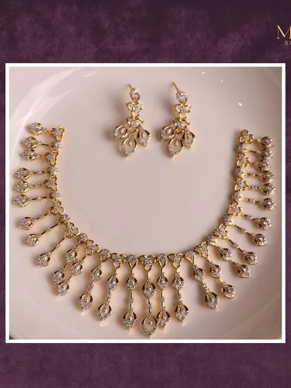 When gold meets grace, magic happens. This cascading diamond necklace and earring set is designed to drape beautifully, catching the light with every movement.