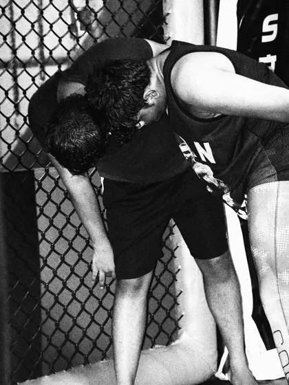Grappling against the cage wall. This is a specific skill set in MMA that we drill constantly. Controlling an opponent here can change the course of a fight.