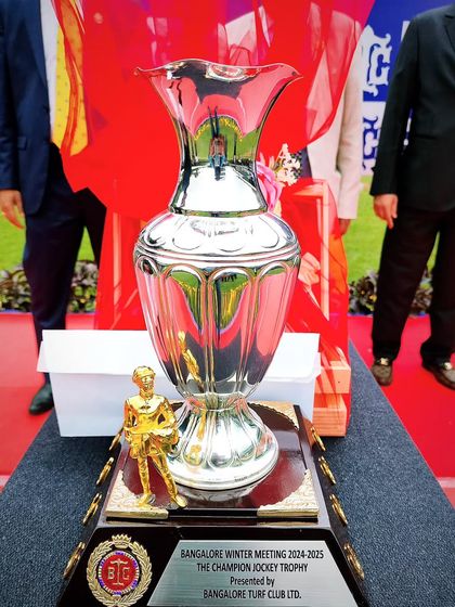The Champion Jockey Trophy, featuring a golden jockey figurine.