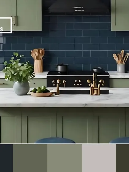 A moody and sophisticated palette combining sage green cabinets with a deep navy blue backsplash and a white marble countertop.