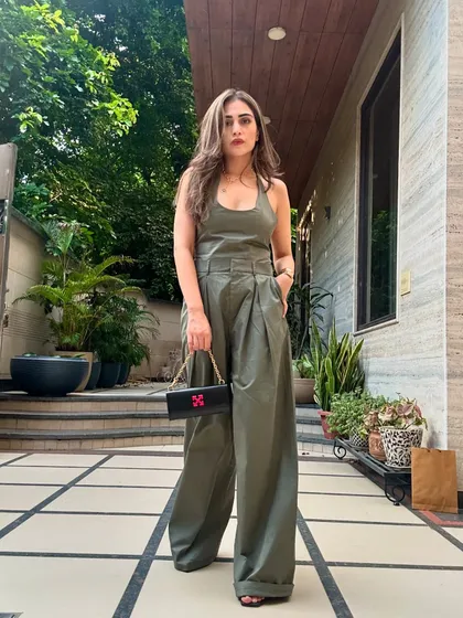 This olive green jumpsuit is a statement piece that requires minimal styling. It's a full outfit in one, perfect for when you want to look chic with little effort.