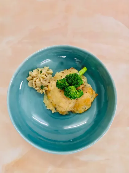Parmesan-crusted perfection. This tender fish fillet rests on a bed of creamy sweet potato mash, offering a delightful plateful of comfort and crunch.