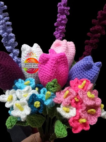 This is a vibrant mixed bouquet featuring an assortment of my handmade flowers. You can see colorful tulips, lavender sprigs, and bunches of forget-me-nots, all crafted from yarn.