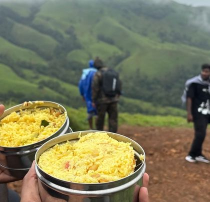 Enjoying a simple, packed meal with a million-dollar view from the Netravati peak. It's the small moments that make the trek special.