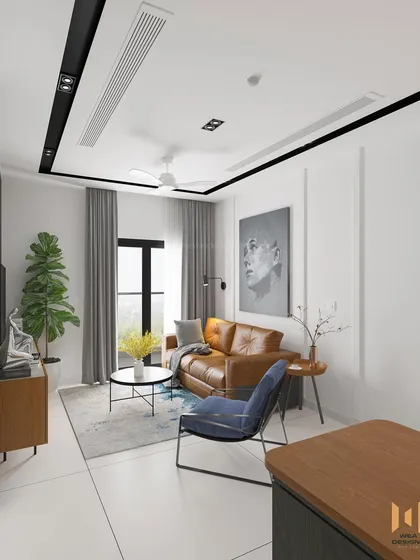 The living area of the Nano Home, with a tan leather sofa, simple white walls with beading, and a compact coffee table.