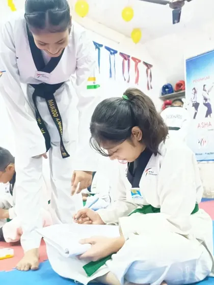 An senior student helps a junior with her written exam. Our team culture is about lifting each other up and sharing knowledge.