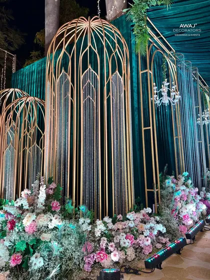 A detail of the walkway decor, showing the beautiful combination of pastel flowers, gold structures, and hanging crystals.
