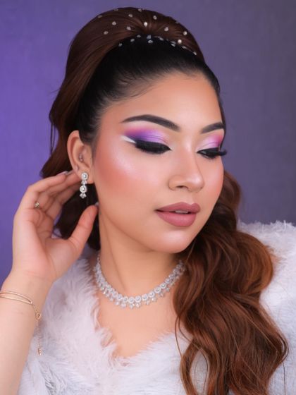 Dive into a world of glam and creativity with this purple and pink graphic eye makeup. The white liner detail adds a futuristic touch, perfect for a creative portfolio.
