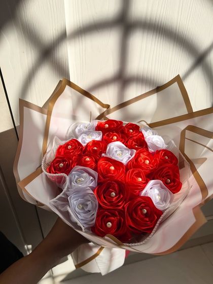 Held in hand, this bouquet of everlasting satin roses is a beautiful symbol of enduring love. I can customize the colors to match any theme or preference.