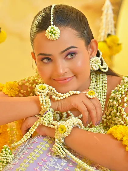 A playful and happy Haldi bride. The makeup is kept minimal and waterproof to withstand the fun and festivities of the Haldi ceremony, while still looking beautiful in photos.