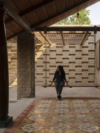 This is from our Kaattu Veedu Guesthouse project, where we embraced earthy and sustainable design. The shaded verandah features handmade Athangudi tiles and restored wooden columns from old homes in Karaikudi, connecting the space to both nature and history.