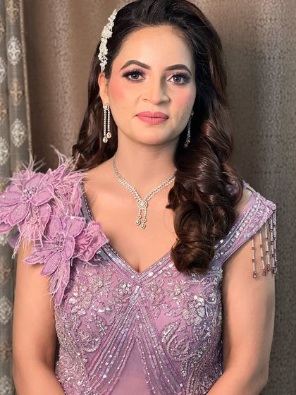 A close-up of this stunning engagement look. The makeup is soft and romantic, with pink shimmery eyes and a matching lip, perfectly complementing her lavender gown.